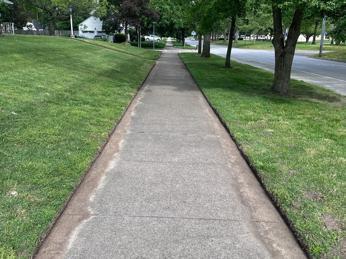 Clean sidewalk edging along residential street in Terre Haute — TEES Lawn Service