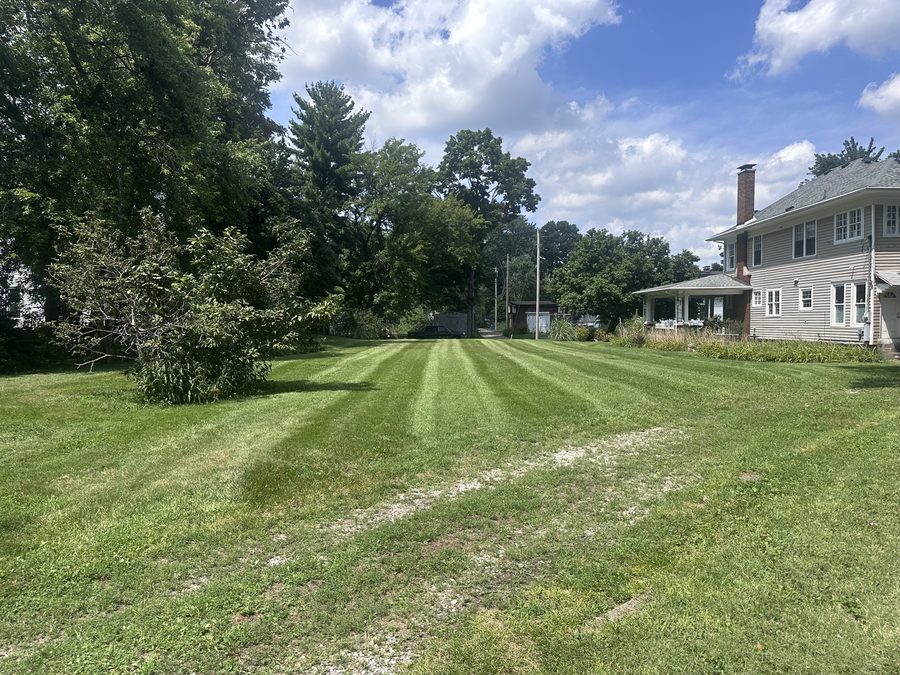 Large residential lawn with clean mowing stripes