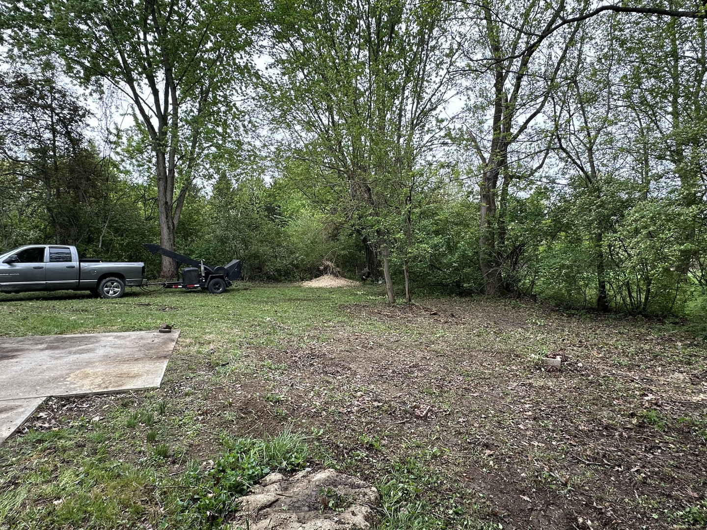 Tees Lawn Service truck and brush chipper working job site in Terre Haute Indiana